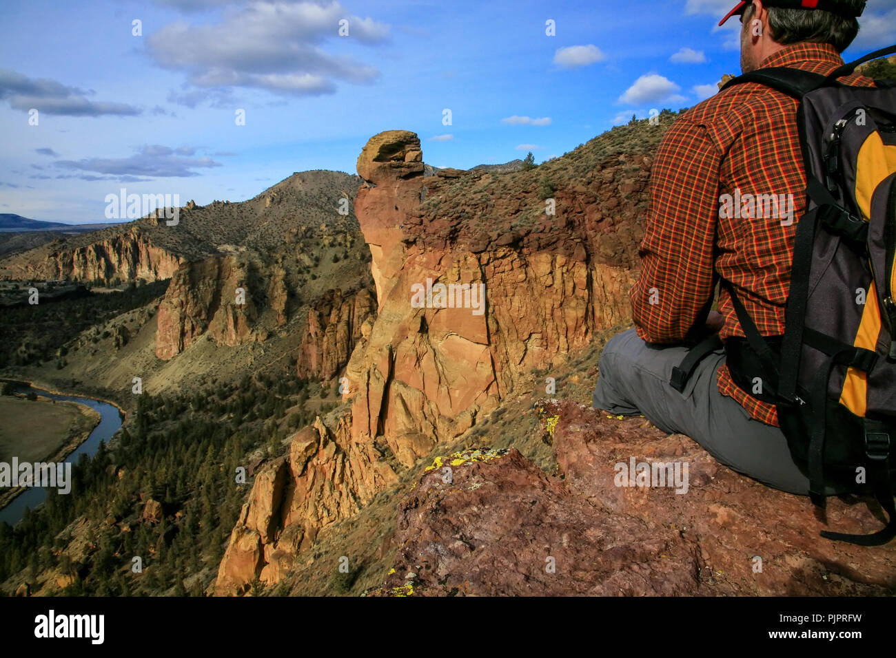 Hiker Sitting on Cliffs at Smith Rock State Park Near Redmond Oregon Stock Photo