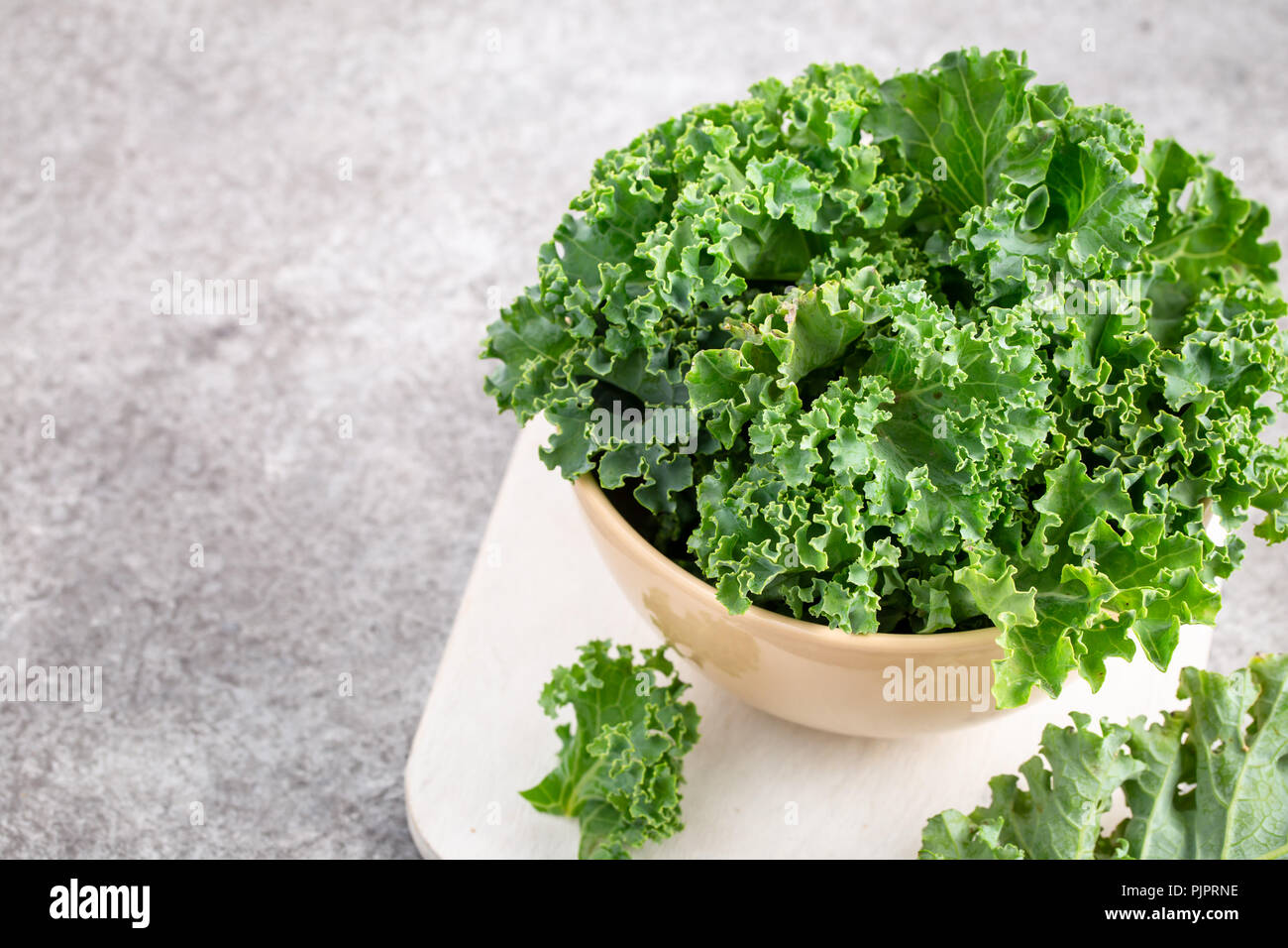 Curly green Kale in bowl Stock Photo
