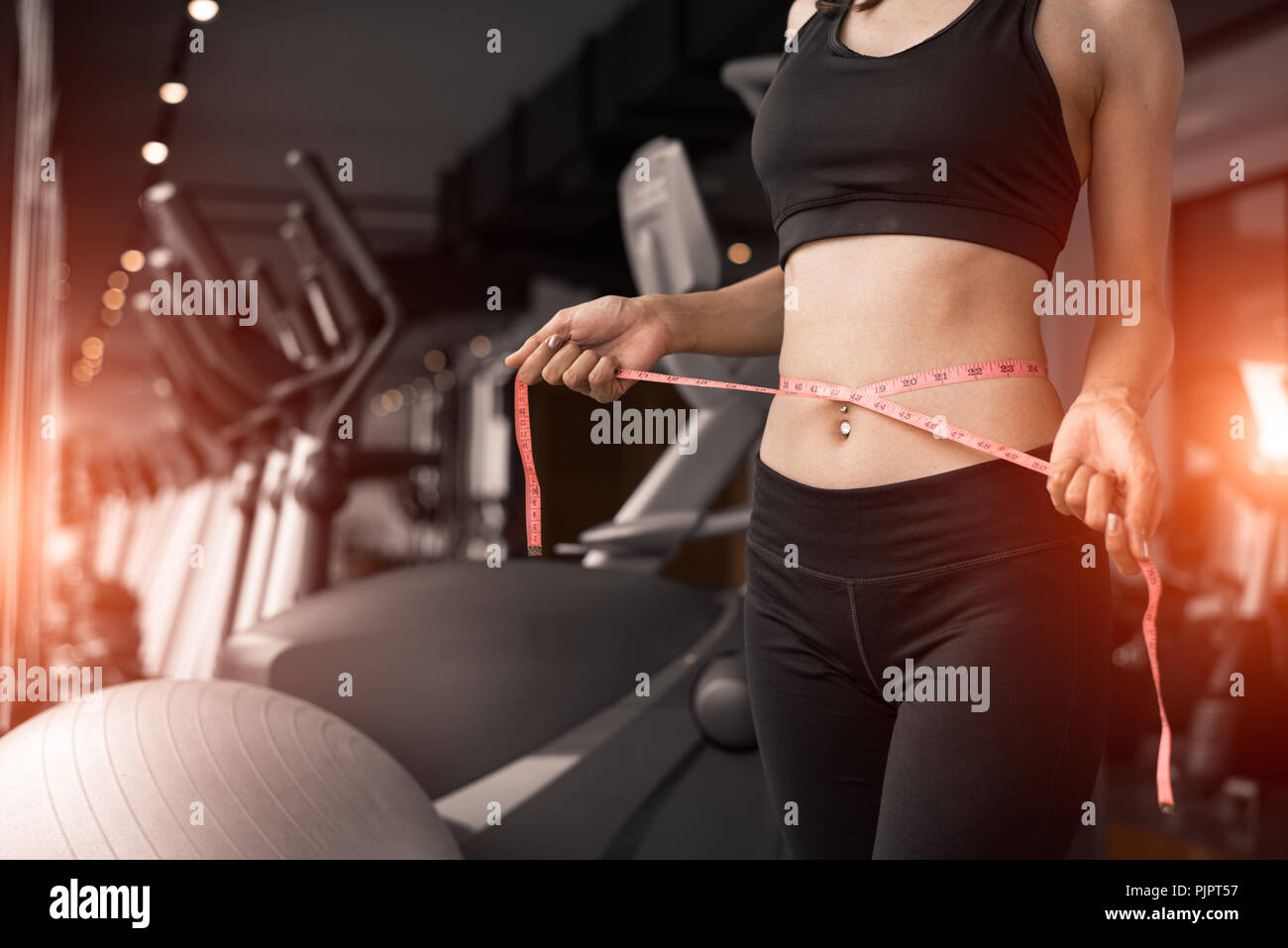 Sporty woman using waist tape line in fitness gym sport club training ...