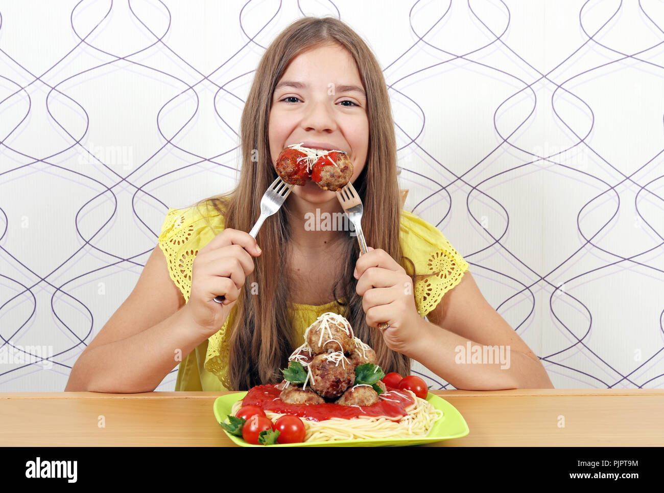 beautiful hungry girl eats meatball Stock Photo