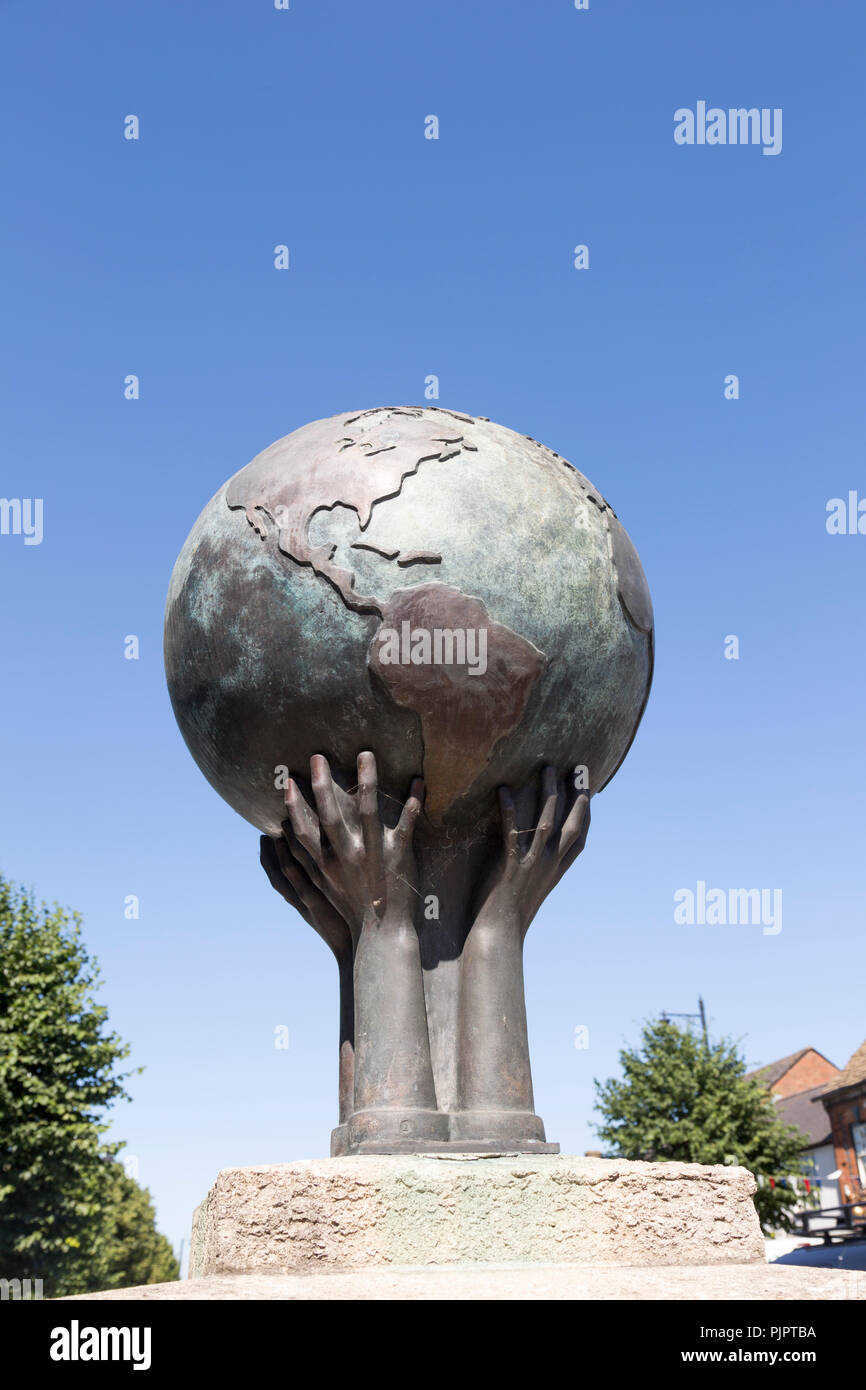 War memorial sculpture showing the world held by hands, Royal Wootten Bassett, Wiltshire, England, UK Stock Photo