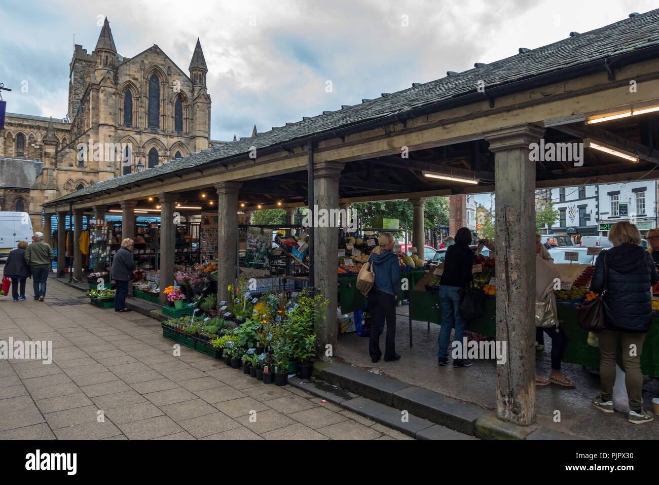 People shopping at The Shambles, a Grade II* covered market built in 1766 in Hexham Northumberland and in regular daily use Stock Photo
