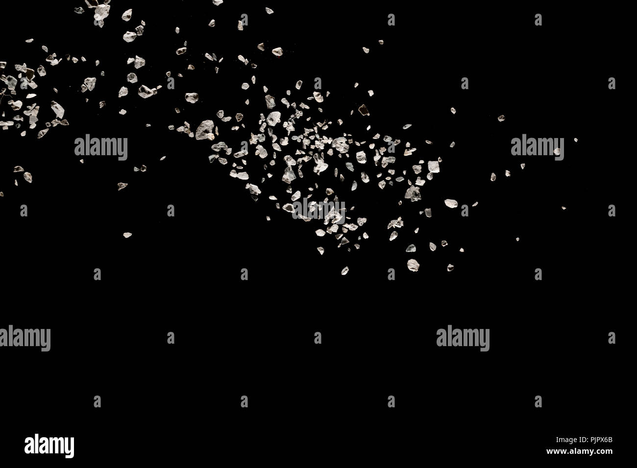 Split debris of stone exploding against black background Stock Photo ...
