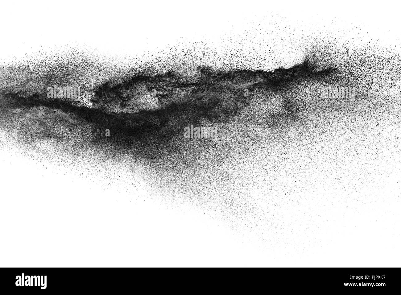 Black particles splattered on white background. Black powder dust splashing. Stock Photo