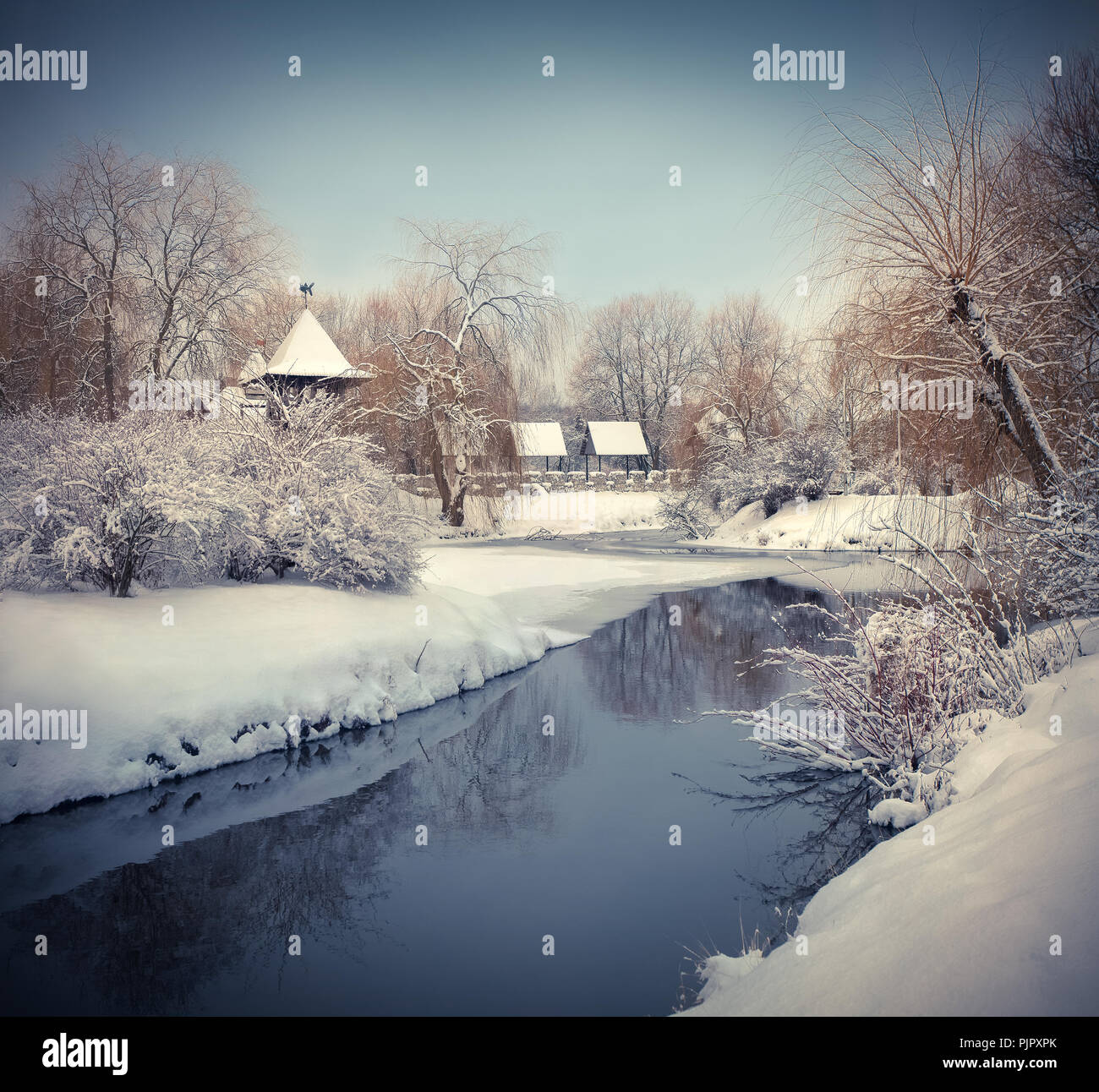 Snow-covered landscape in the city park. Retro style. Stock Photo