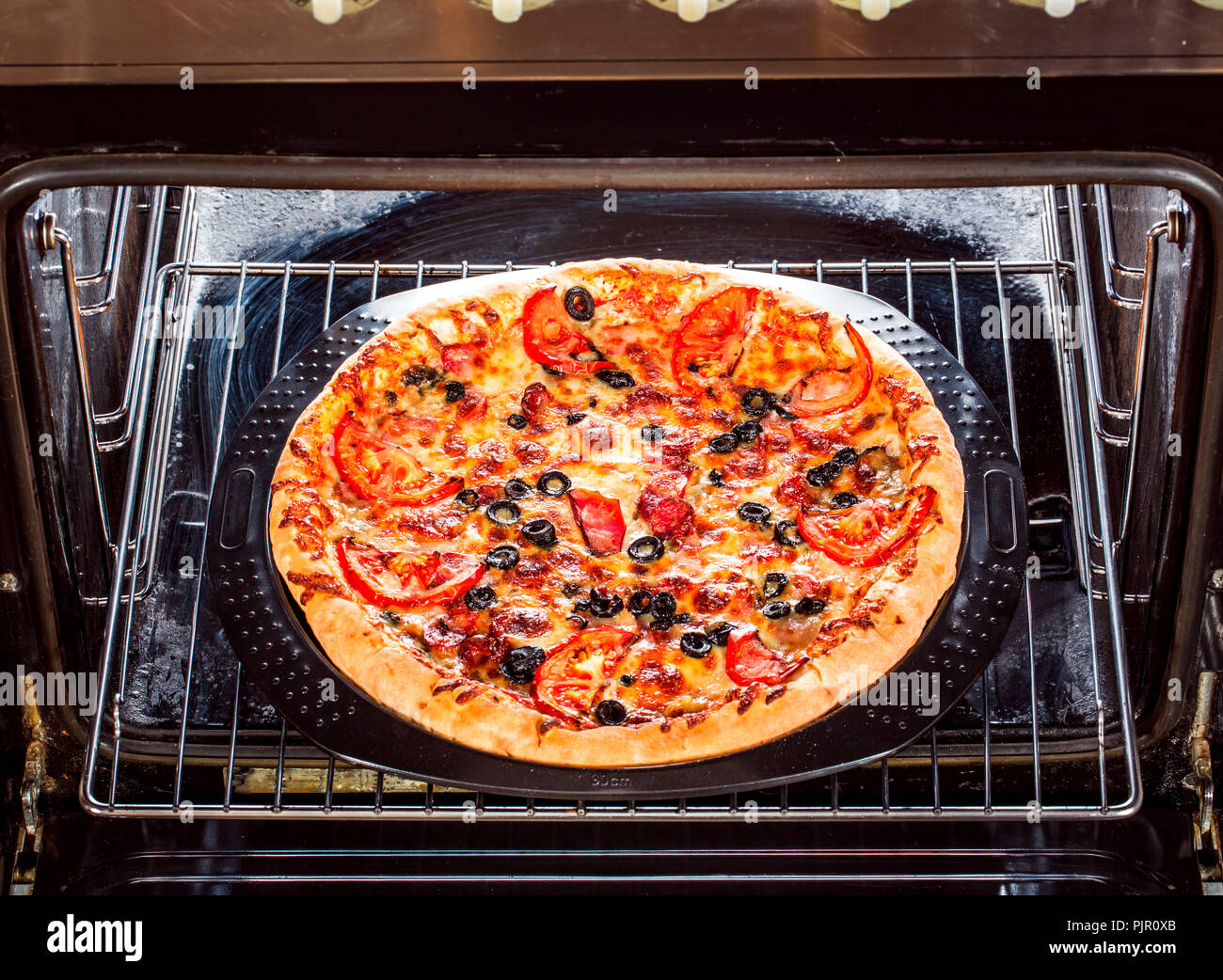 Appetizing pizza in the oven, Cooking in the oven Stock Photo Alamy