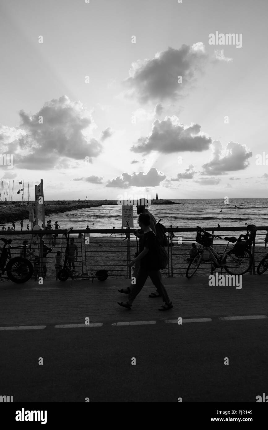 People walking sunset in Black and White Stock Photos & Images - Alamy