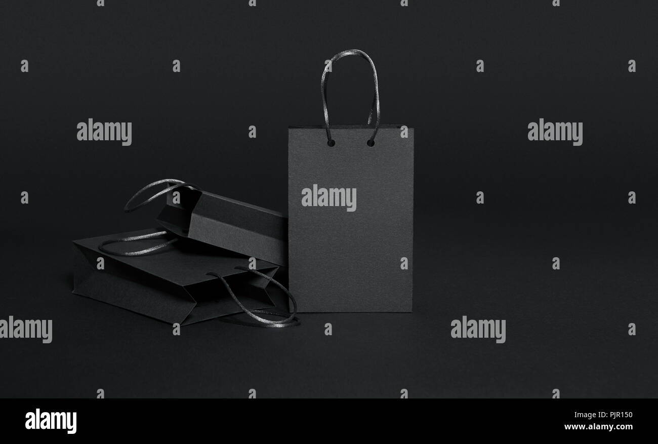Black shopping bags on black background Stock Photo