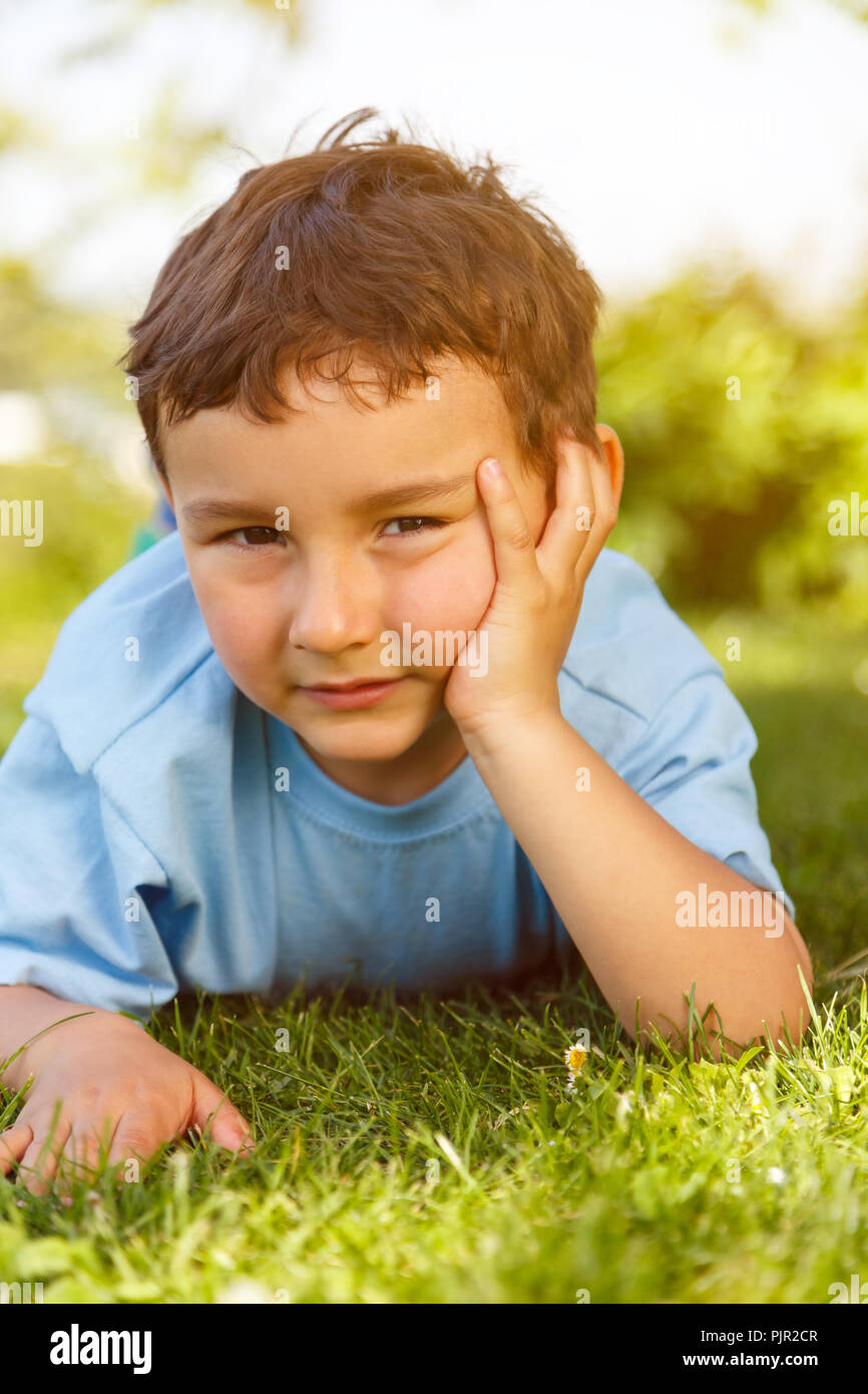 Child kid little boy thinking think looking outdoor portrait format vertical Stock Photo