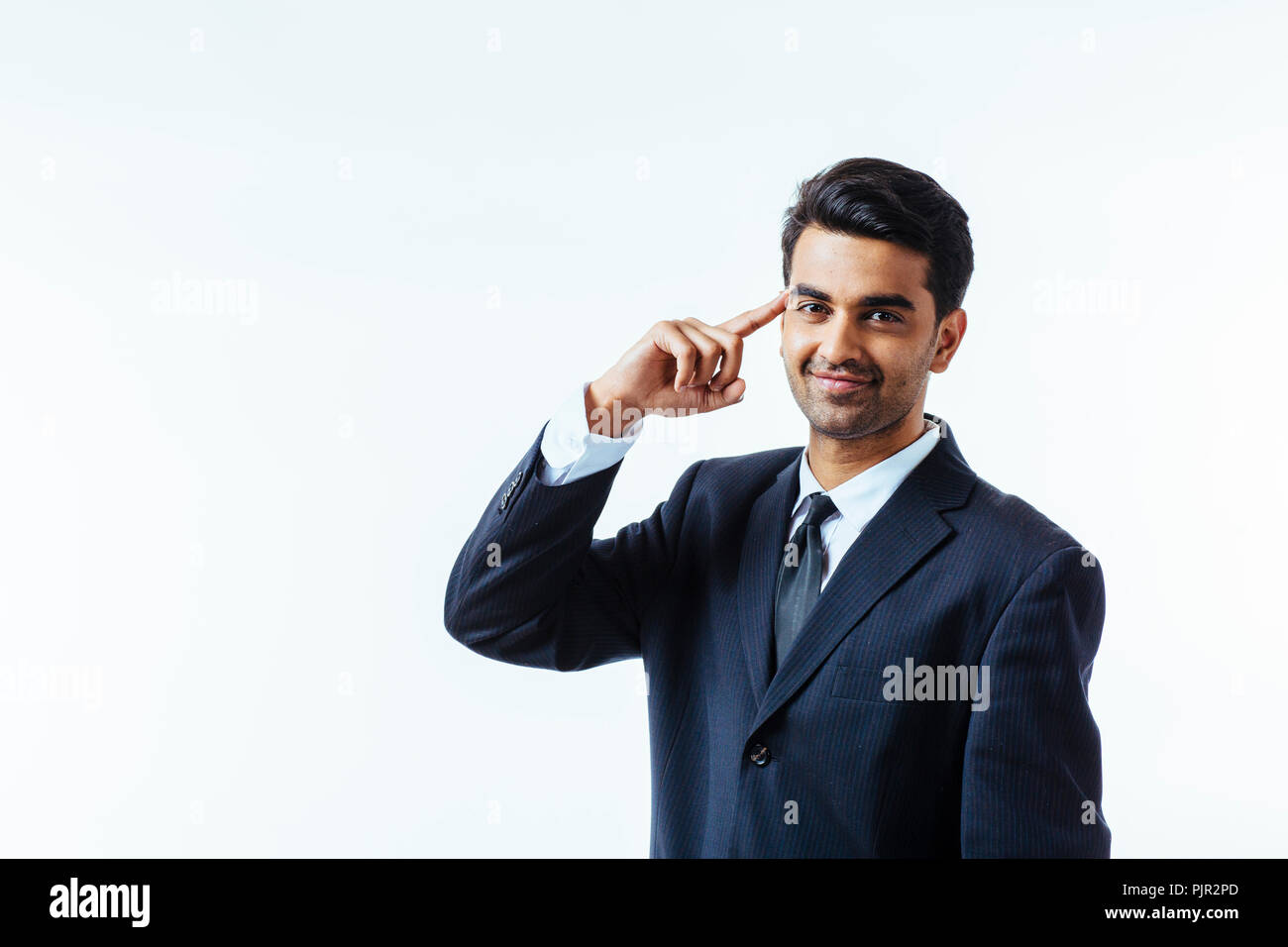 Portrait of a good looking businessman with one finger on his temples. isolated on white background Stock Photo