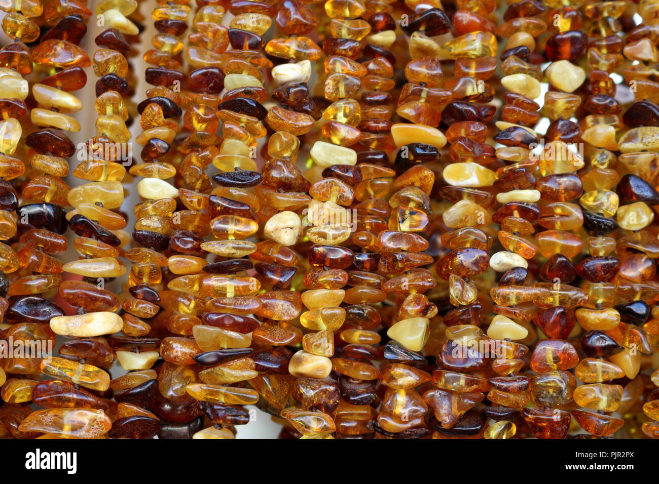 Amber stones of different shapes and color shades Stock Photo