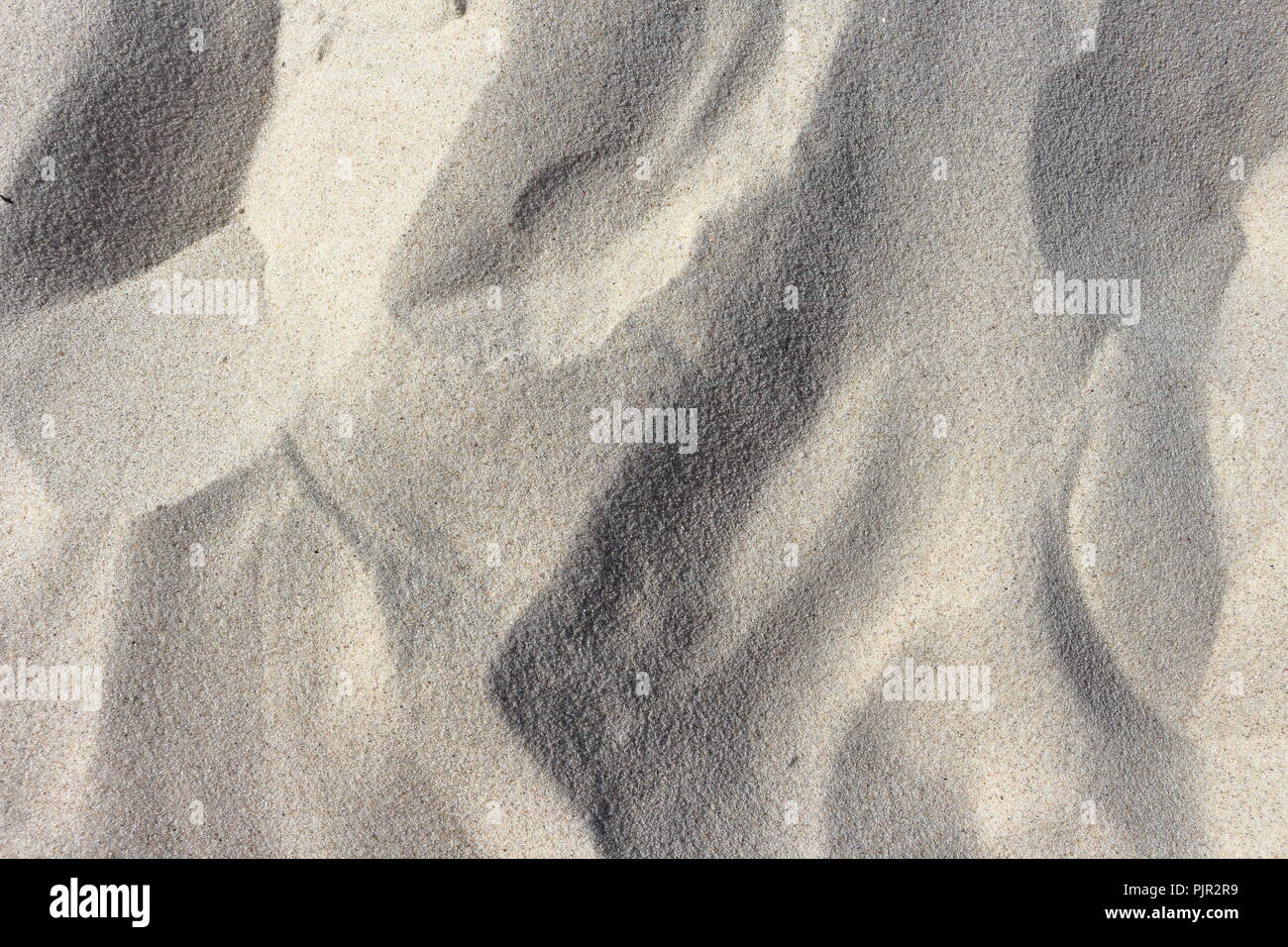 Closeup of beach sand forming mini dunes in the wind Stock Photo