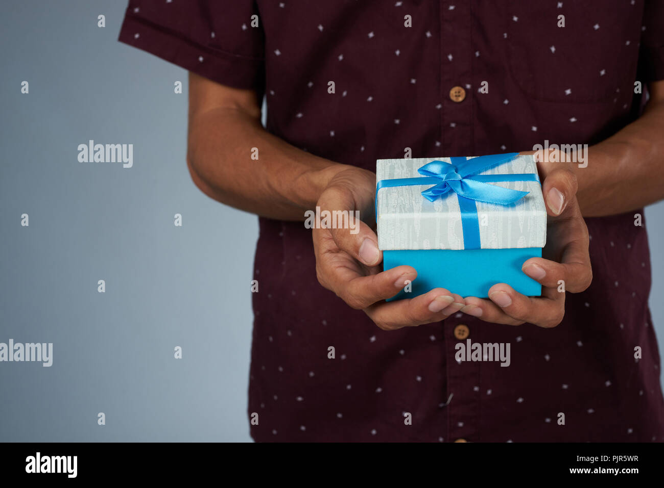 Giving small blue gift box theme. Present for birthday concept Stock Photo