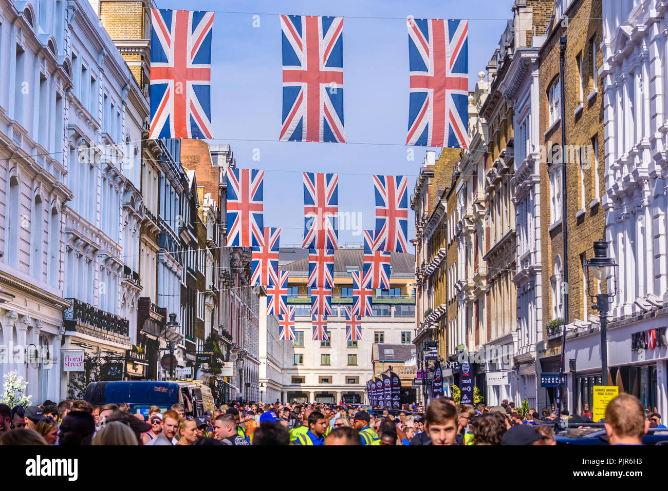 Many Union Flags Union Jacks flying above a street in London Stock