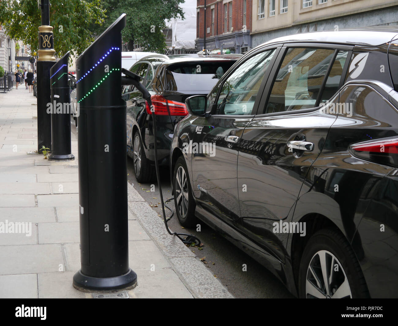 Electric cars charging at a charging point on a London street Stock