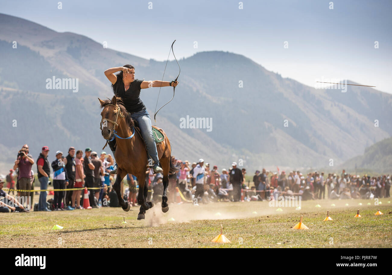Issyk-Kul, Kyrgyzstan, 6th September 2018: american woman competing in archery on horseback game Stock Photo