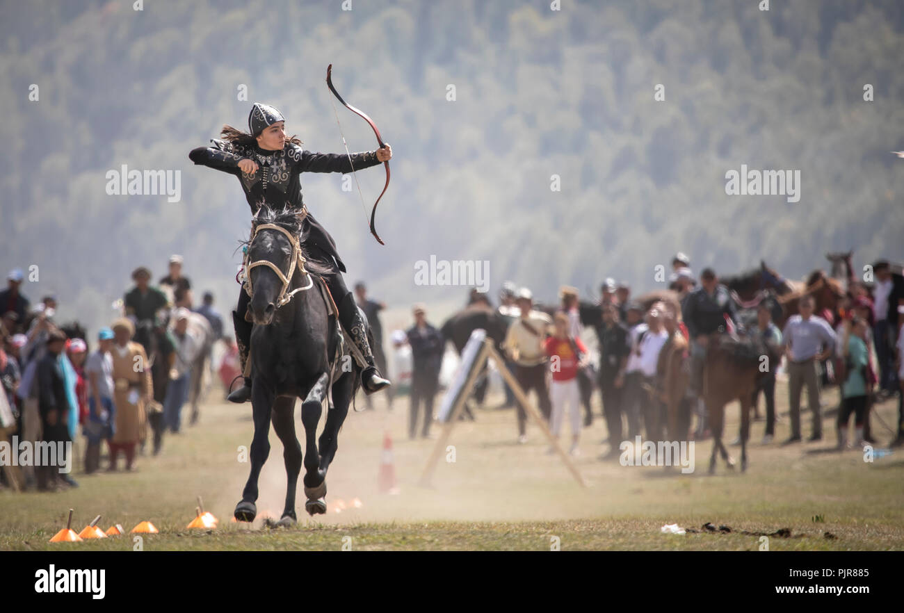 Lake Issyk-Kul, Kyrgyzstan, 6th September 2018: Woman competing in archery on horseback game Stock Photo