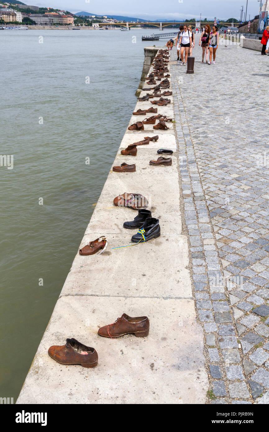 Tourists visiting the Shoes on the Danube Bank Memorial, conceived by Can Togay sculpted by