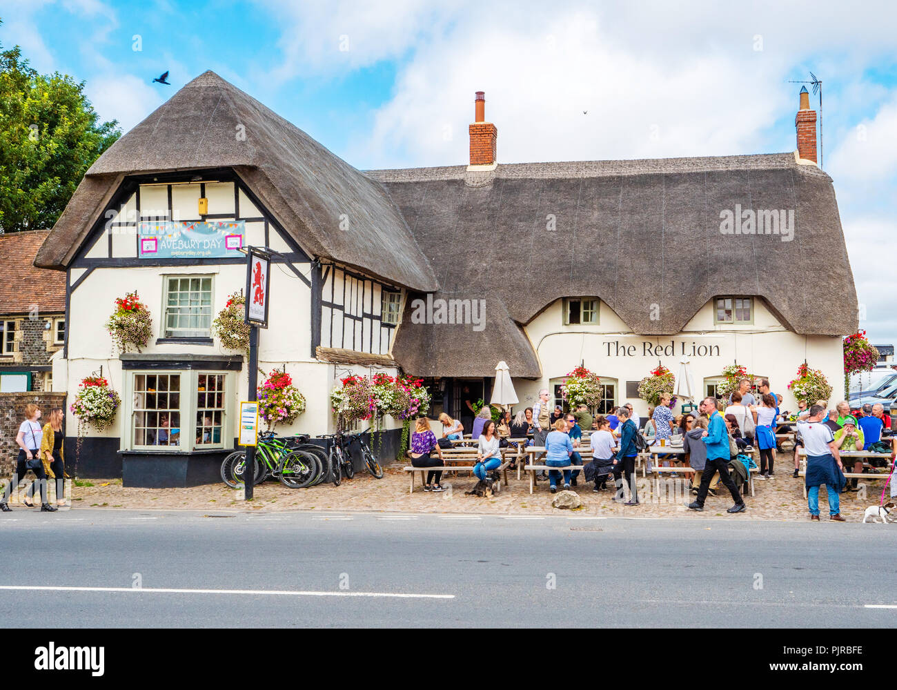 The popular Red Lion pub at Avebury neolithic henge in Wiltshire UK which contains a village with pub and three stone circles within its circumference Stock Photo