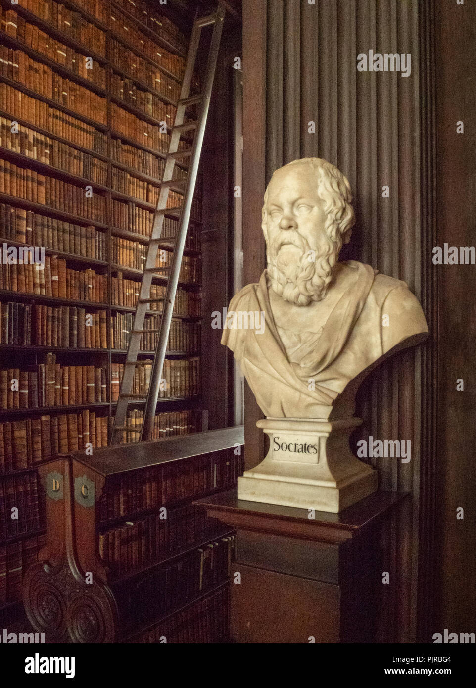 Magnificent oak panelled interior of Trinity College Library in Dublin Ireland with busts of