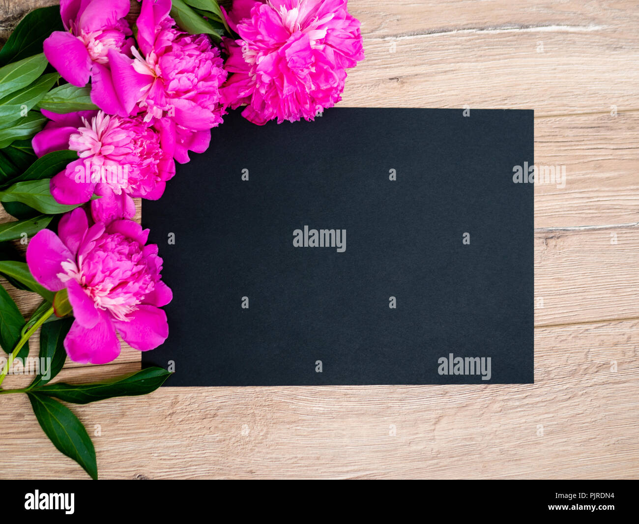 Pink floral assorted pink flower on wooden background with black paper free space, copy space for tekst Stock Photo