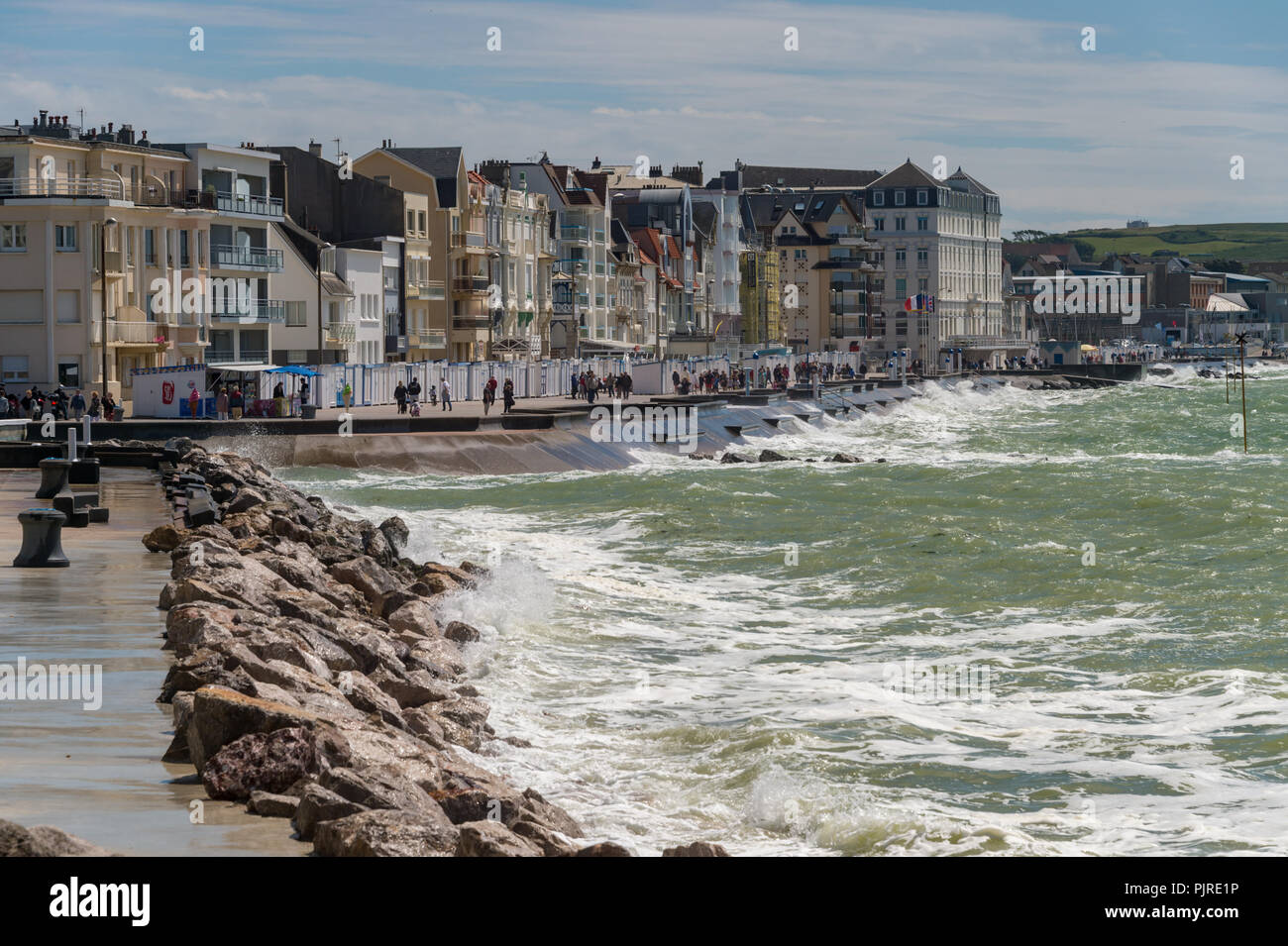 Wimereux, France - 16 June 2018: Wide angle view of the waterfront promenade with waves hitting the sea wall. Stock Photo