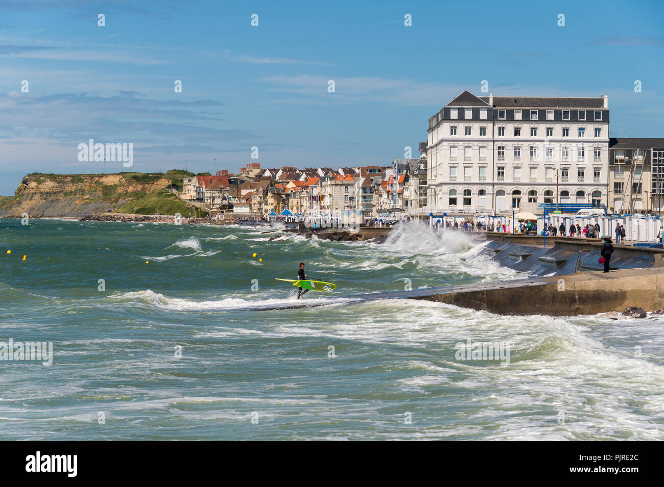 Wimereux, France - 16 June 2018: View of the sea front promenade as waves are hitting the seawall. Stock Photo
