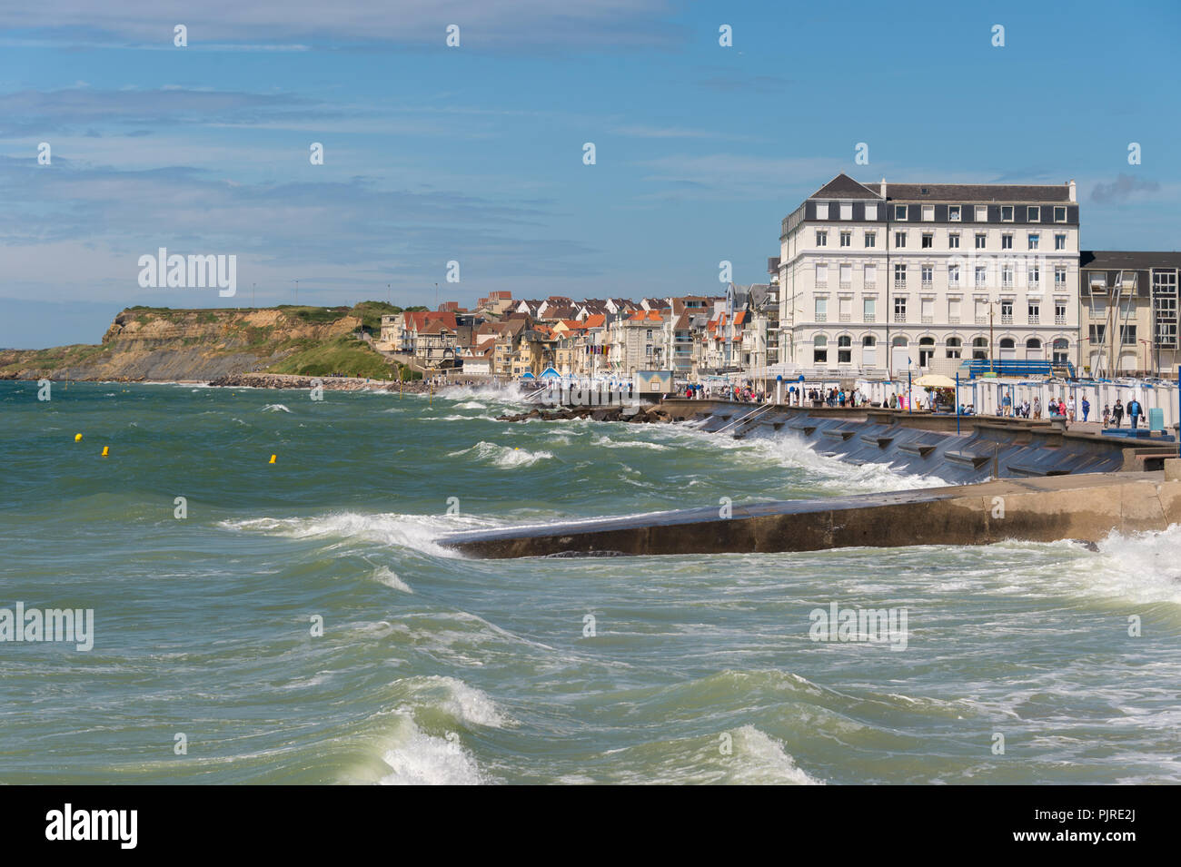 Wimereux, France - 16 June 2018: View of the sea front promenade as waves are hitting the seawall. Stock Photo