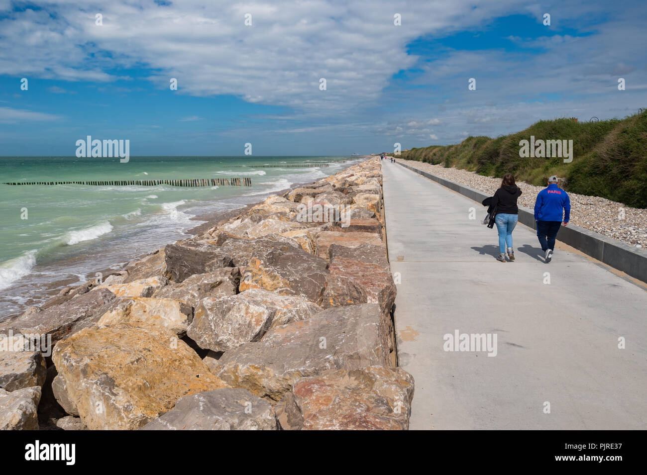 Sangatte, FR: 16 June 2018: The new concrete seawall has been built to protect the land and the dunes against sea level rise due to global warming. Stock Photo