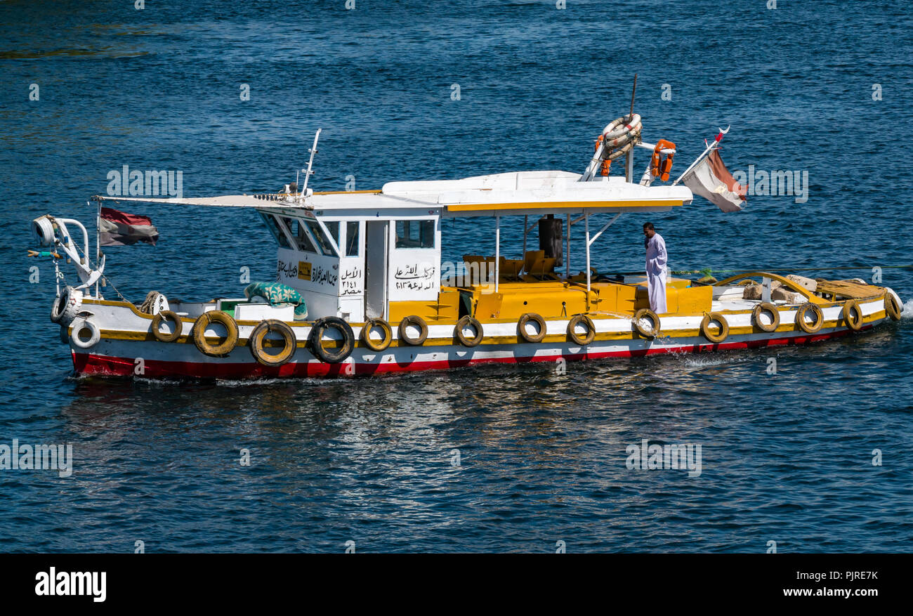 Colourful working tug boat with tyre fenders or bumpers and Egyptian man in  traditional robe, Nile River, Egypt, Africa Stock Photo - Alamy