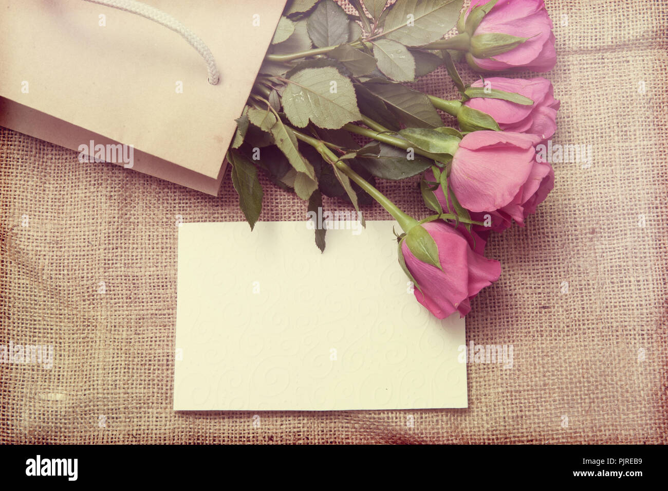 Background with pink roses and greeting card Stock Photo - Alamy