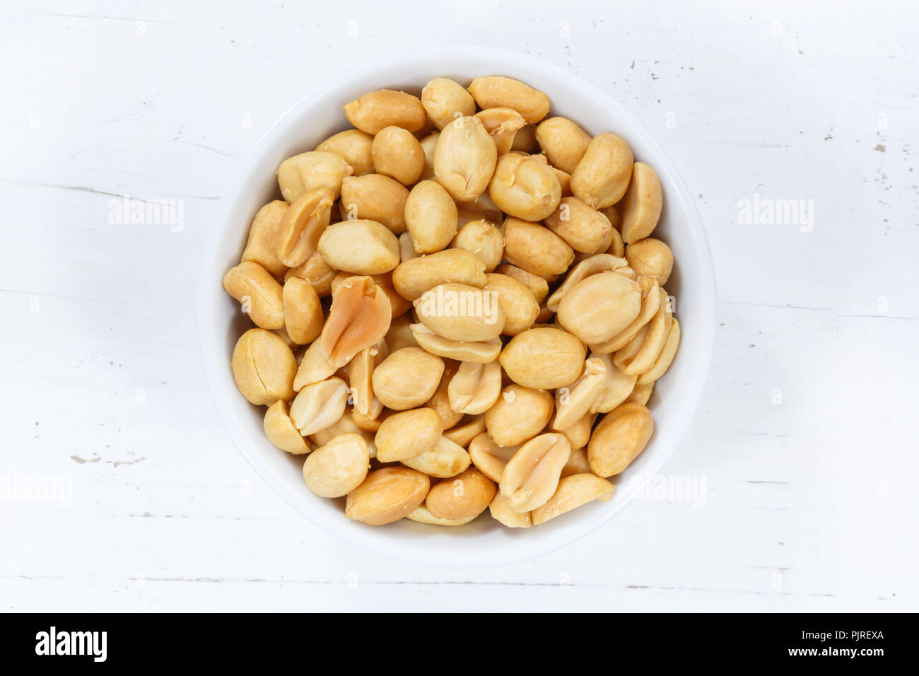 Peanuts nuts from above bowl wooden board wood Stock Photo