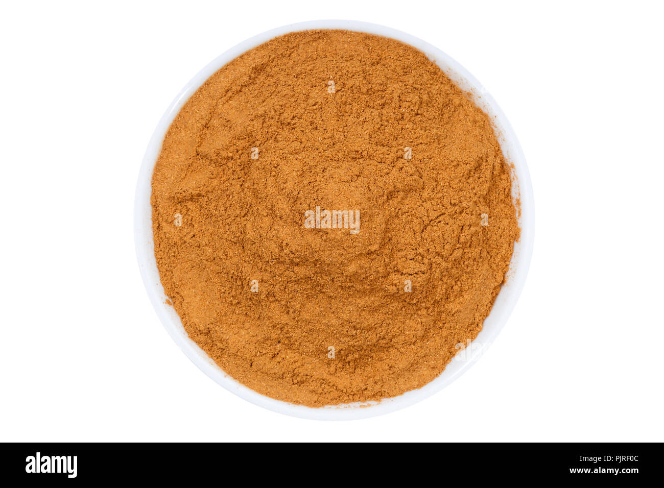 Cinnamon spice powder from above bowl isolated on a white background Stock Photo
