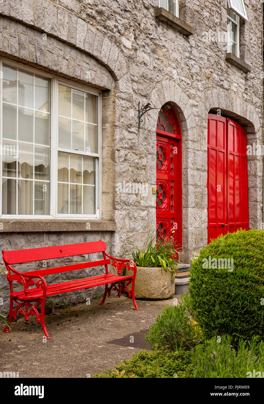 Ireland, Co Leitrim, Drumsna, red painted house beside old stone bridge