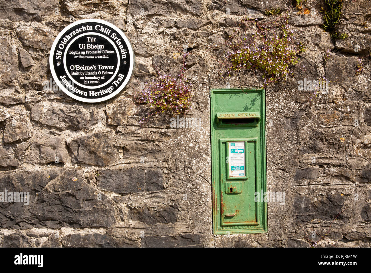Ireland, Co Leitrim, Jamestown, Heritage Trail, O’Beirne’s tower plaque and green post box in stone wall Stock Photo