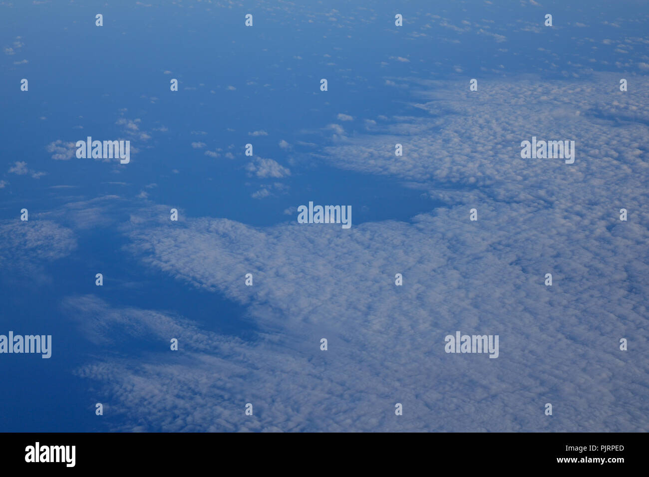 Blue sky with clouds, view from the flying airplane Stock Photo - Alamy