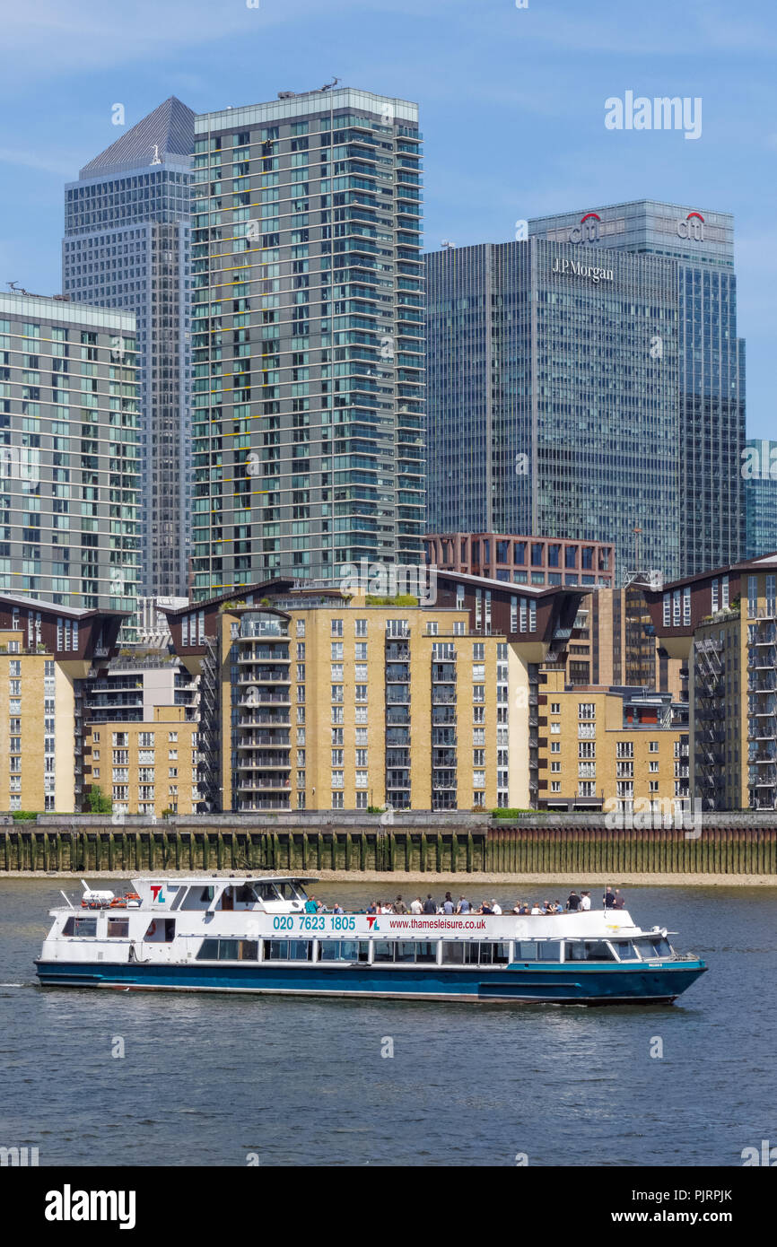 Cruise boat on the River Thames with Canary Wharf skyscrapers in the ...