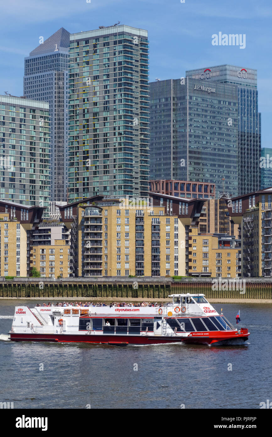 Cruise boat on the River Thames with Canary Wharf skyscrapers in the ...