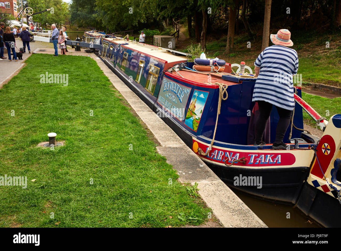 A pair of canal hotel boats going through the locks at Audlem village Stock Photo