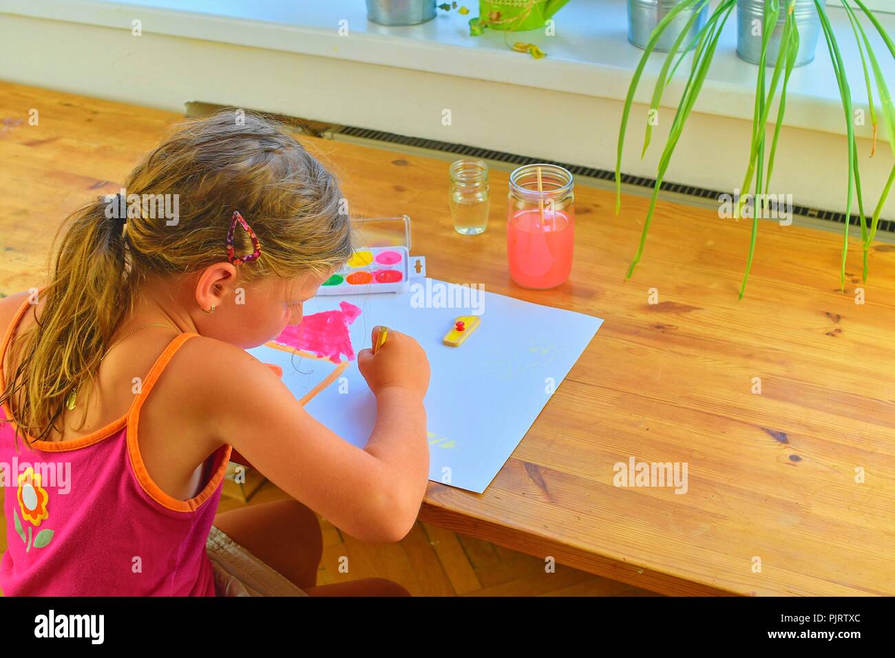 Little girl painting simple picture. Cute girl painting with