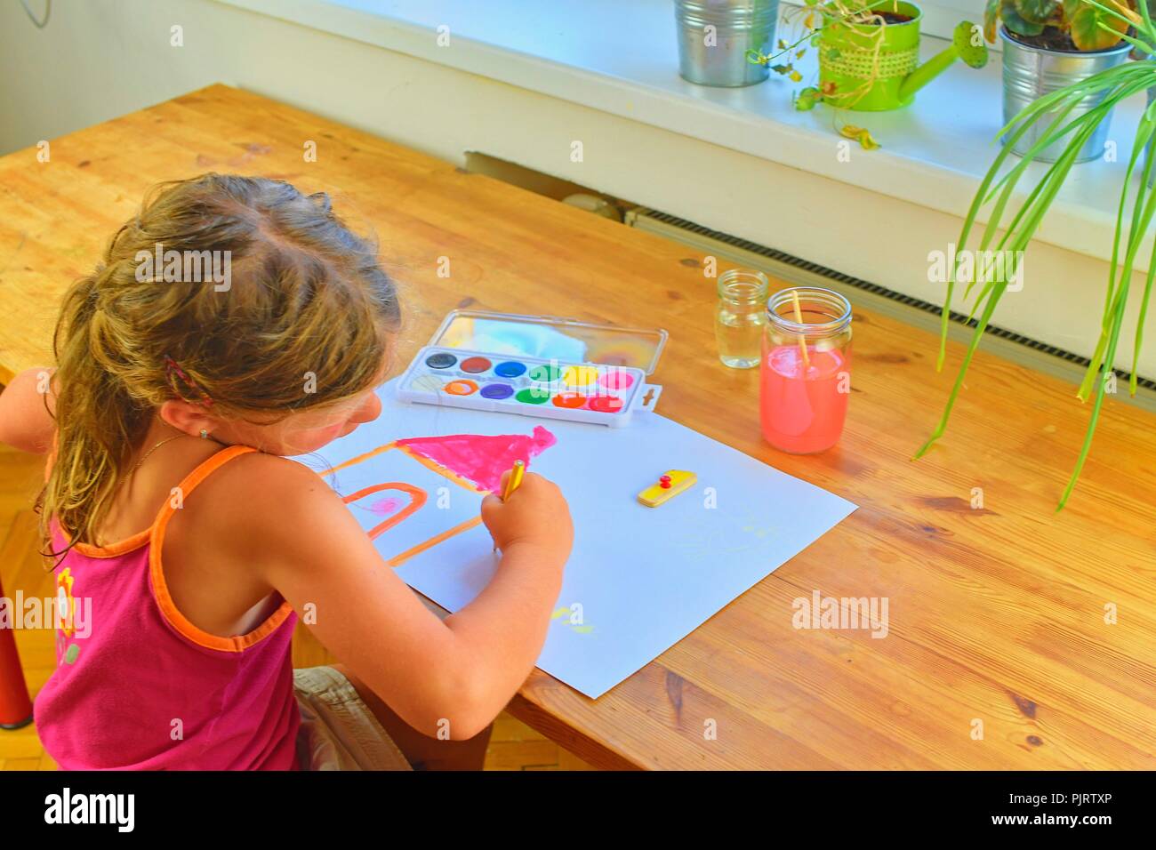Little girl painting simple picture. Cute girl painting with