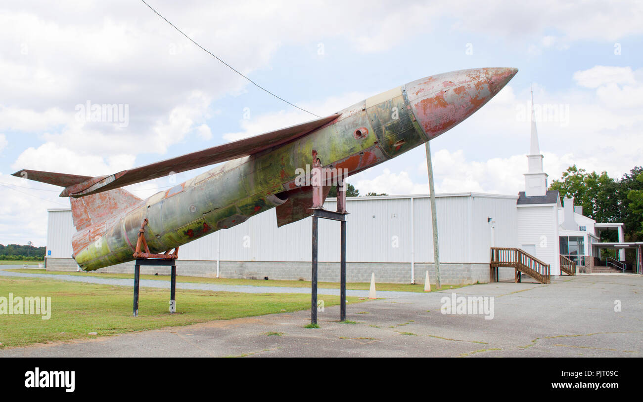 Decommissioned cruise missile jet displayed outside a church in Pikeville, North Carolina—faith and firepower in curious contrast. Stock Photo