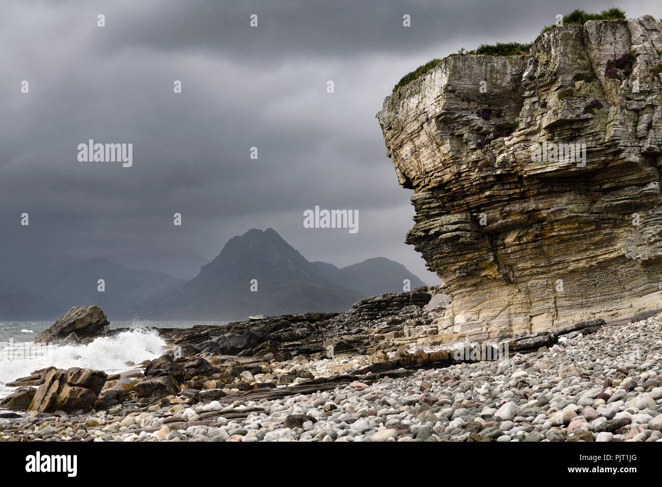 Elgol beach at Port na Cullaidh with Red Cuillin Mountains under clouds on Loch Scavaig Scottish Highlands Isle of Skye Scotland UK Stock Photo