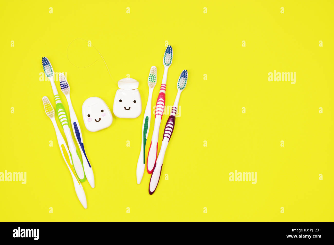 Toothbrushes and dental floss on yellow background,top view Stock Photo ...