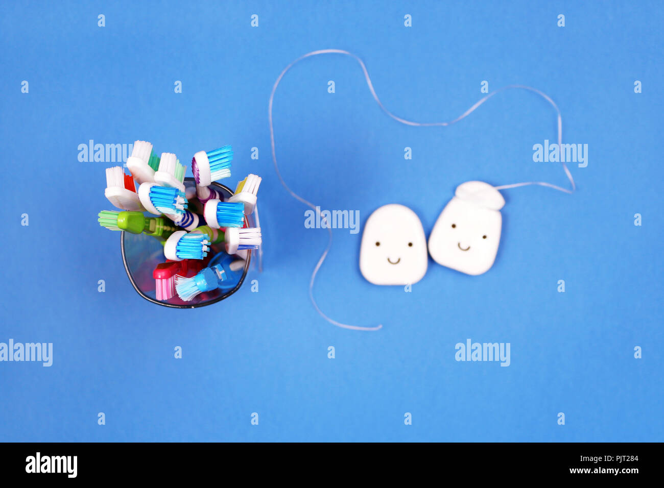 Toothbrushes and dental floss on blue background, top view Stock Photo ...