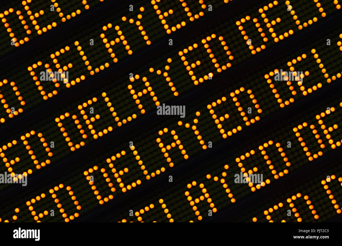 A Close Up Of The Word Delayed Repeated Multiple Times On A Sign At A Station Or Airport Or Highway Stock Photo