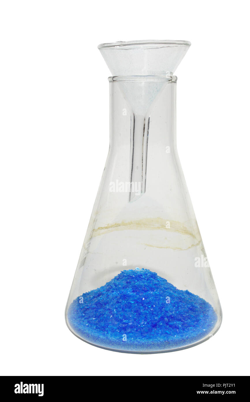 chemical experiment:  blue powder, poured into heap, through the small lab funnel on a bottom of transparent conical flask. isolated, with clipping pa Stock Photo