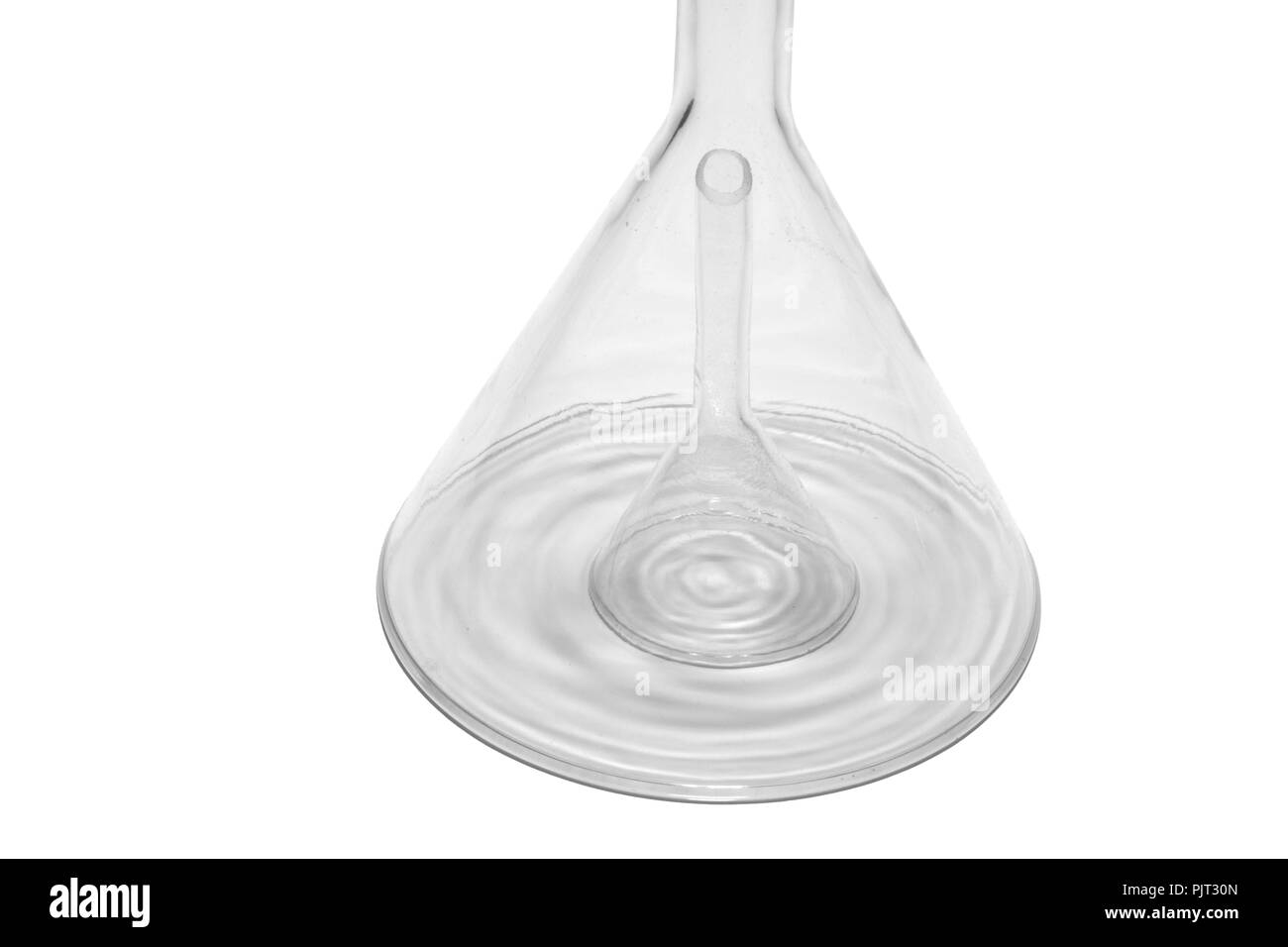 glass laboratory funnel covers smaller one, and casts concentric shadows. isolated on white background, with clipping path Stock Photo