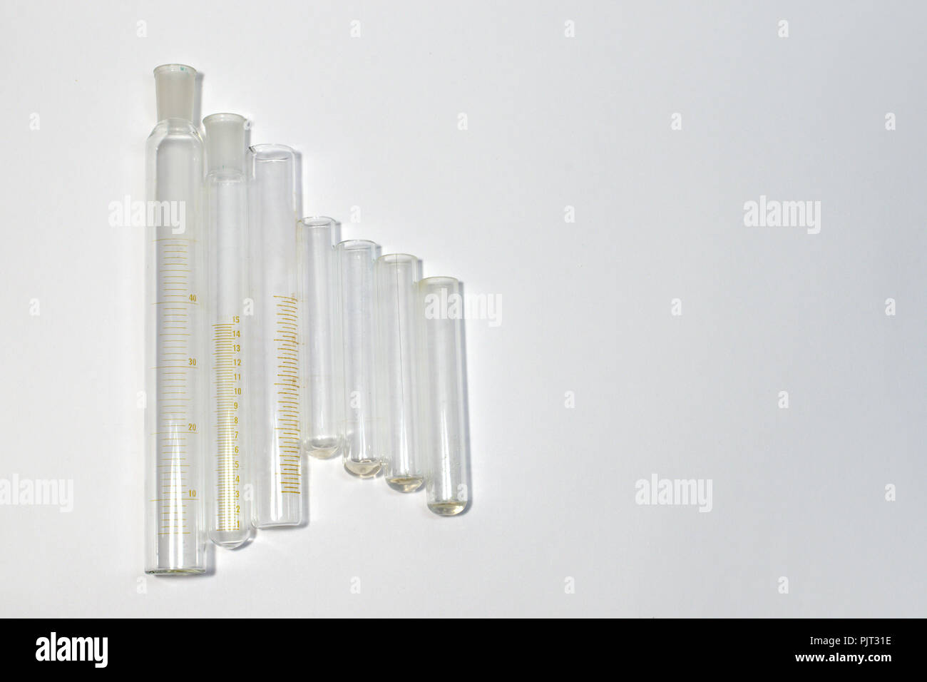 staggered row of laboratory equipment; empty graduated cylinders of