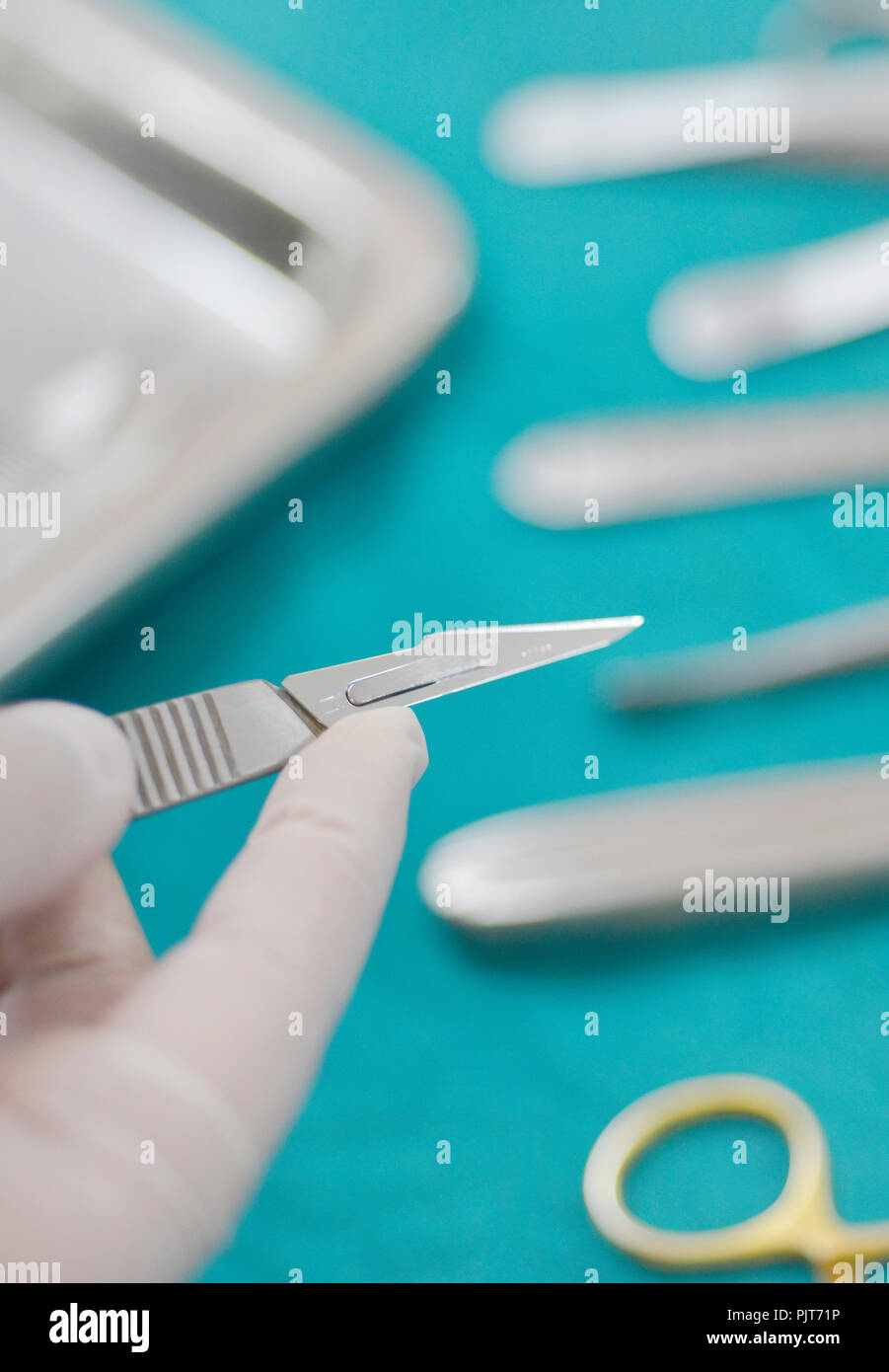 Close up hand holding surgical instruments in the operating room. Stock Photo